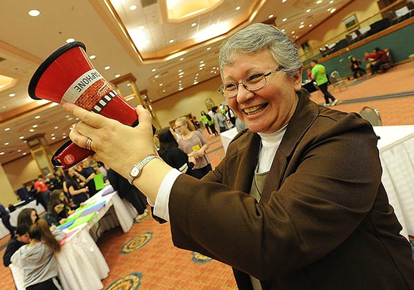 Felician Sister JoAnne Suranni signals the beginning of the Expo as Catholic Youth head into the Grand Ballroom of the Adams Mark Hotel during the 